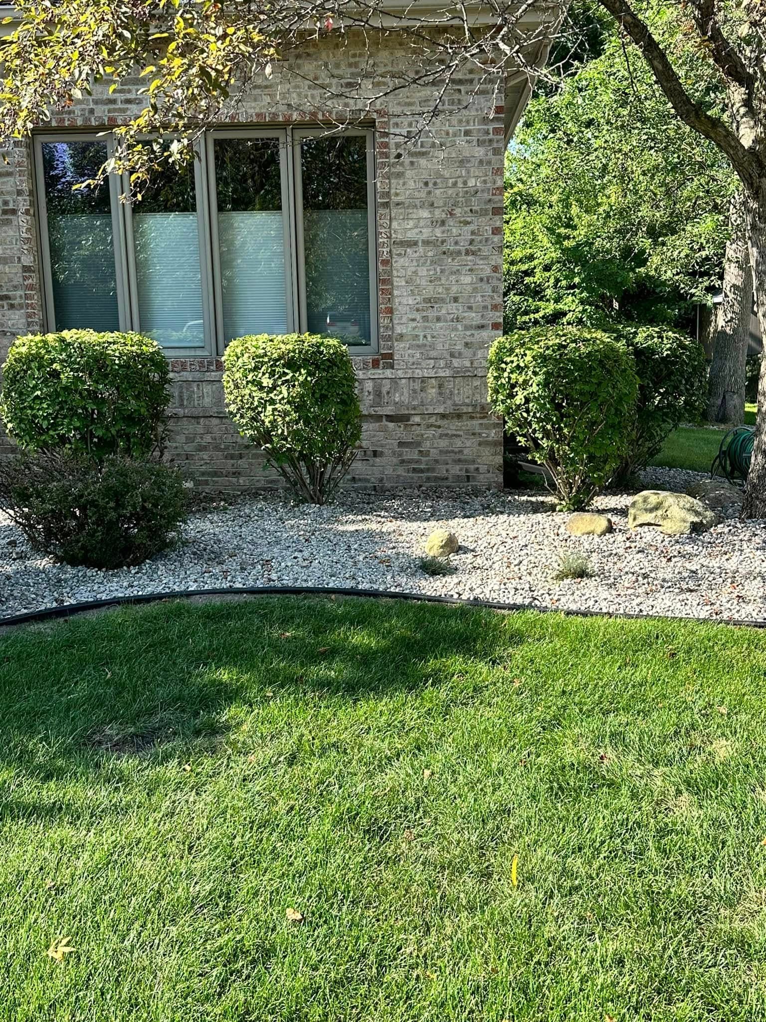 Clean lawn edge along a gravel bed after weed whacking